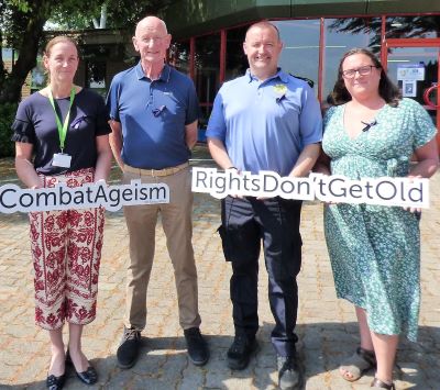 Brian Cody is joined by 3 other people, 2 women and 1 man. They are holding signs with 'combat ageism' and 'rights don't get old' on them.