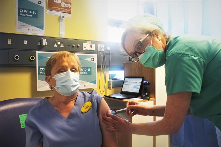 UHL ED Triage Nurse Rosaline O’Brien receiving her vaccine from Intensive Care Consultant Dr Catherine Motherway