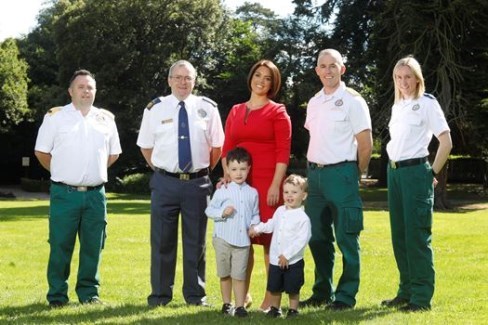 Cardiac arrest survivor Emma Doyle and her children Henry and George with NAS personnel involved in her rescue 