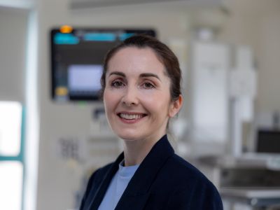 A woman smiling in a clinical setting.