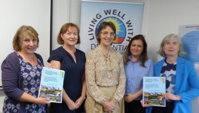 5 female members of the The Living Well with Dementia in South Tipperary project holding their report