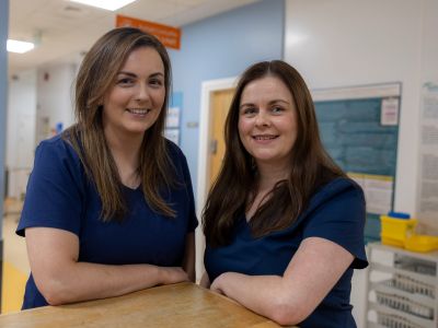 Two nurses in a clinical setting.