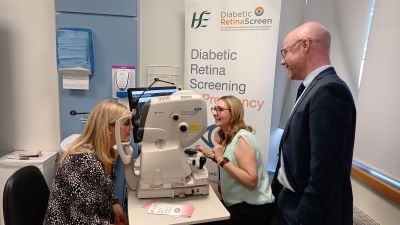 Minister for Health Stephen Donnelly watches as patient advocate Vicky Doyle (left) has her eyes screened by Karen O’Connor of the Mater Misericordiae University Hospital