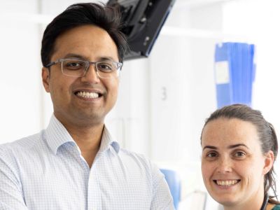 A man and woman indoors in a clinical setting.