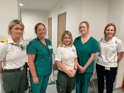 The five female Kerry Pathfinder team members in uniform standing smiling.