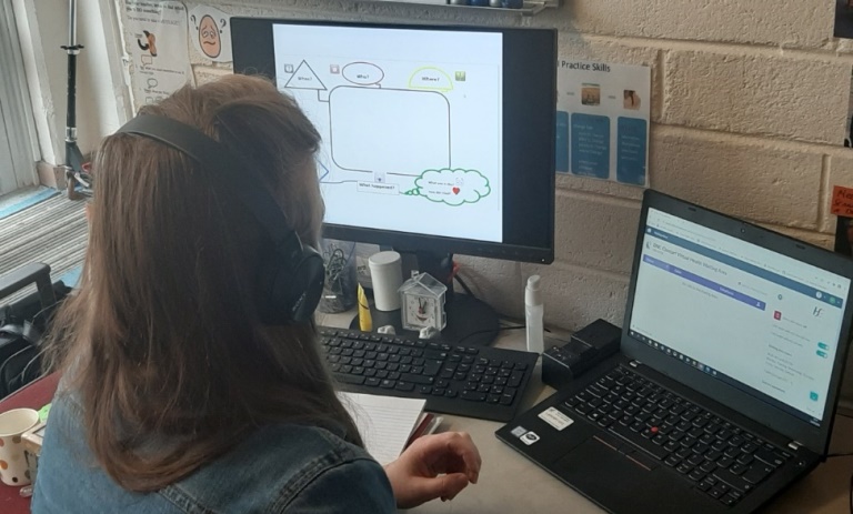 A speech and language therapist in CHO Dublin North City and County works with one of her young clients using the Attend Anywhere online system.