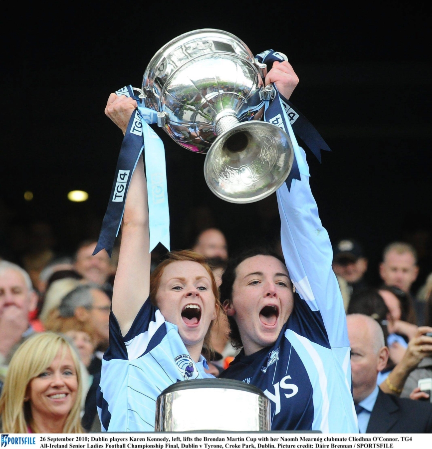 Former Dublin player Karen Kennedy (left), lifts the Brendan Martin Cup in 2010 with her Naomh Mearnóg clubmate Clíodhna O'Connor. Karen is a vaccinator and Public Health Nurse, with HSE Community Healthcare Organisation Dublin North City and County. Photo: Dáire Brennan / SPORTSFILE.