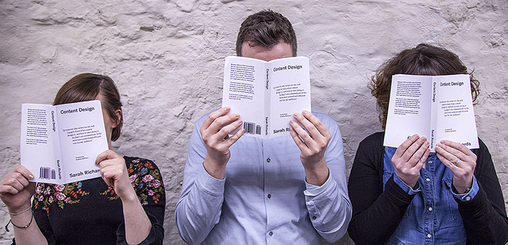 mage of HSE digital team members holding up 'Content Design' book by Sarah Richards