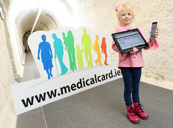 Picture of child holding smartphone and tablet at mymedicalcard.ie launch in Dr Steevens' Hospital